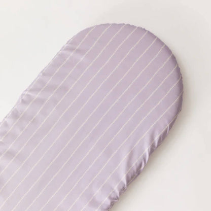 A lilac fitted sheet laid flat, showing a rounded mattress shape and evenly spaced stitched vine stripes.