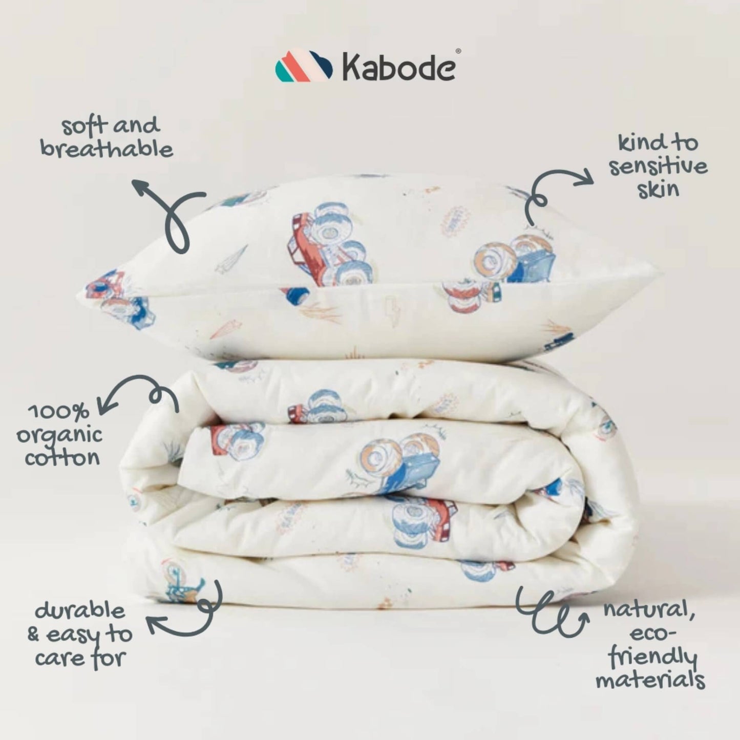 Folded duvet and pillow stacked neatly to show fabric detail, stitching, and the repeating vehicle pattern across the surface.