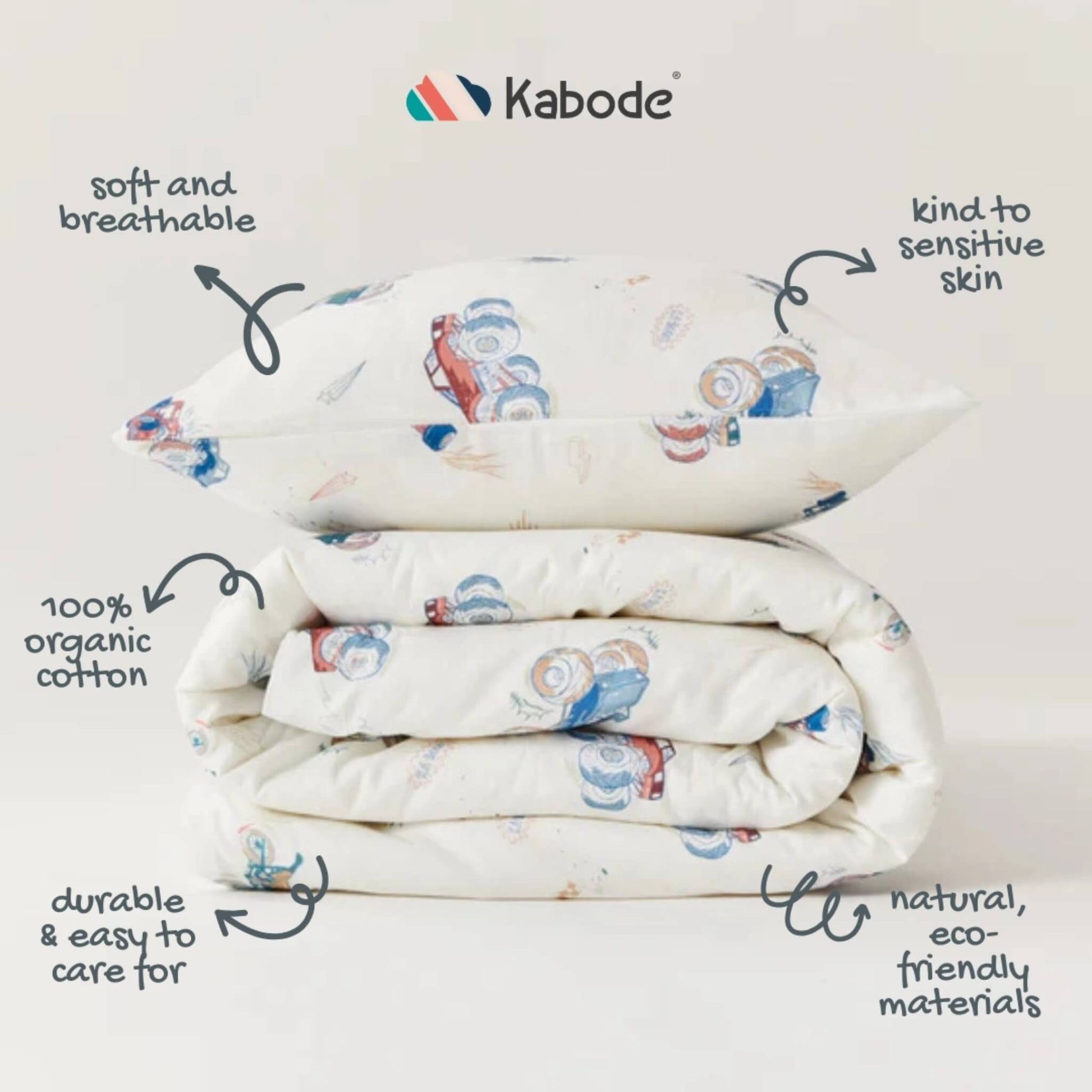 Folded duvet and pillow stacked neatly to show fabric detail, stitching, and the repeating vehicle pattern across the surface.