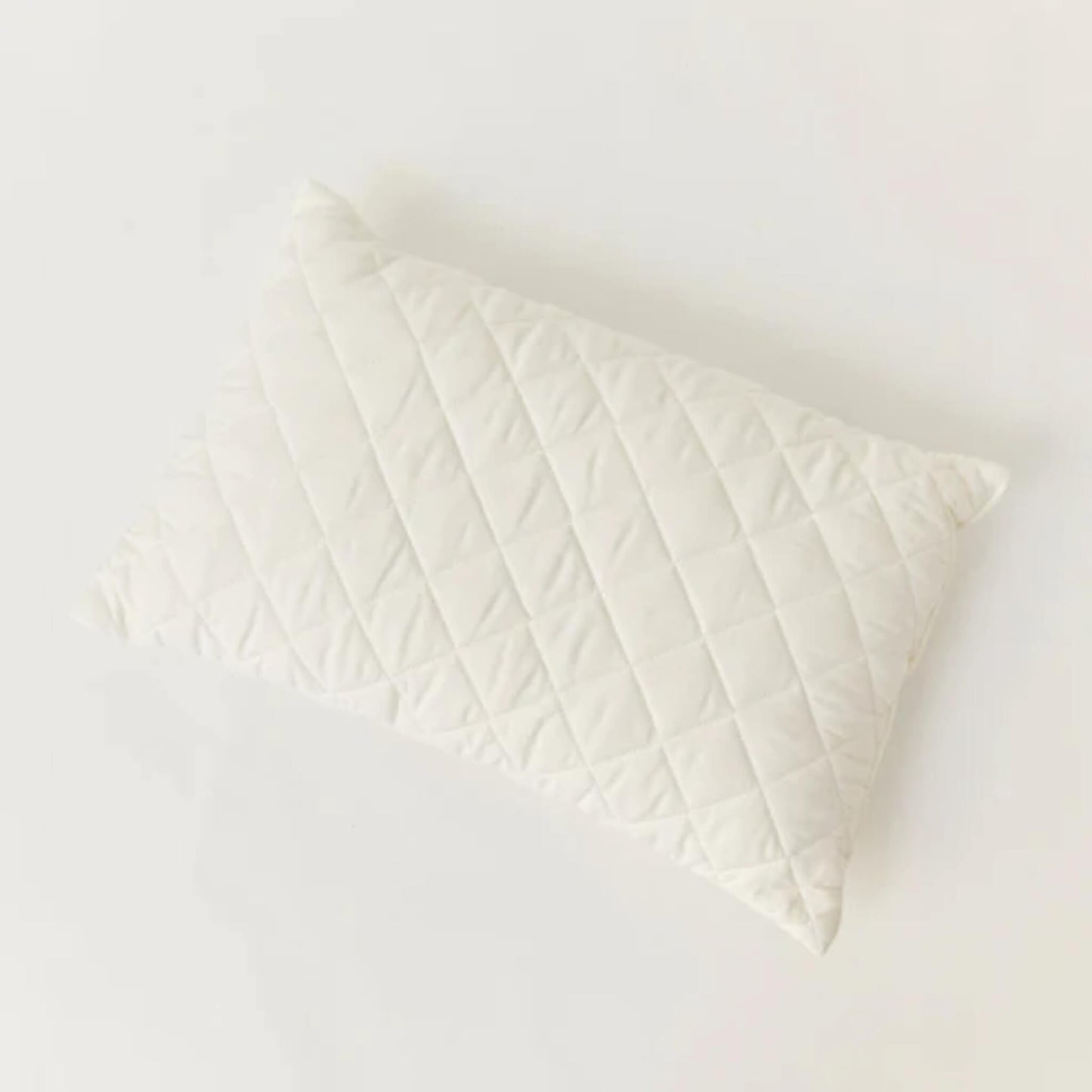 Kabode Wool Toddler Pillow shown from above, featuring a quilted organic cotton cover with diamond stitching on a soft neutral background.