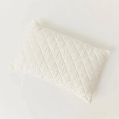 Kabode Wool Toddler Pillow shown from above, featuring a quilted organic cotton cover with diamond stitching on a soft neutral background.