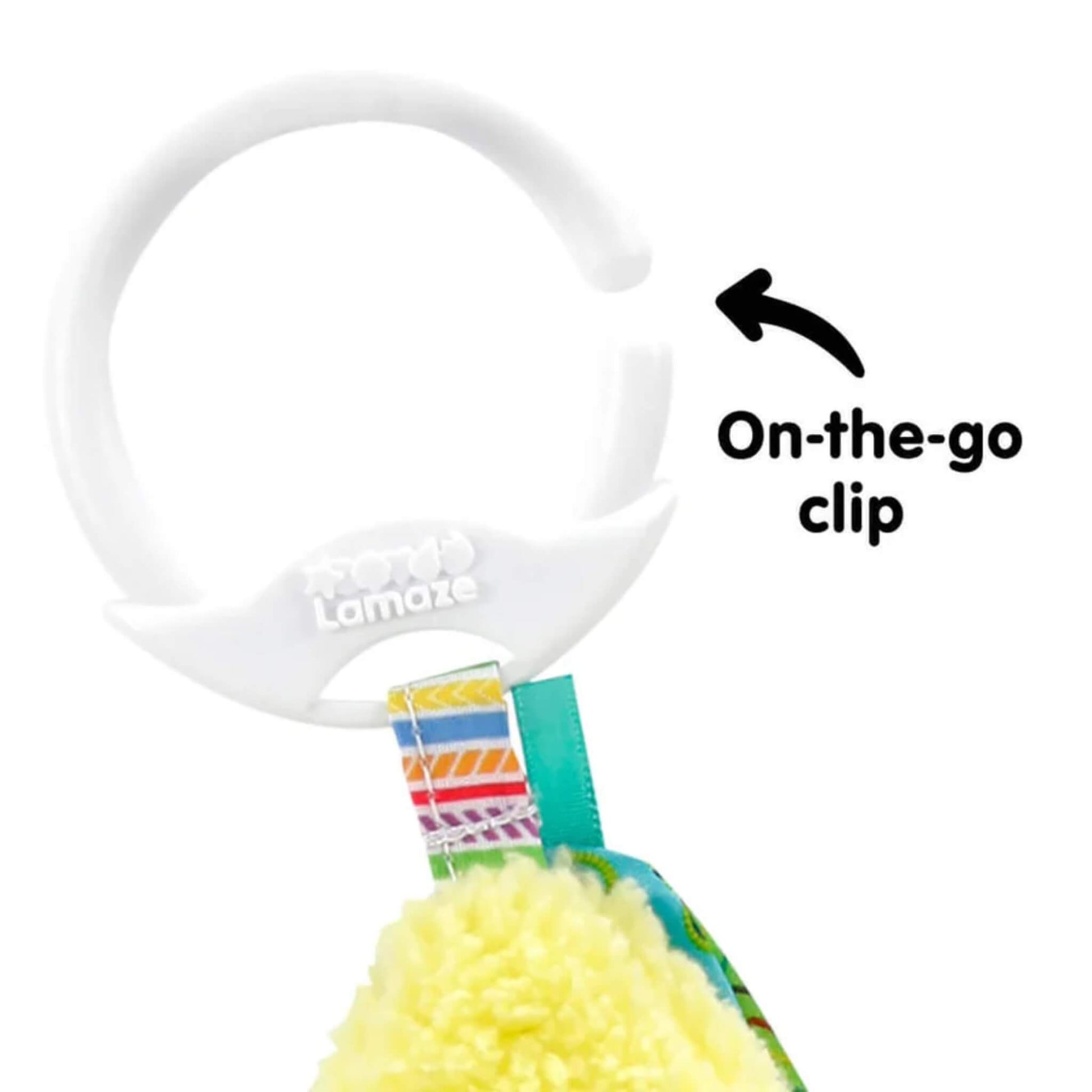 Close-up of a white plastic clip at the top of a soft baby toy, designed to attach the toy to prams, car seats, or changing bags.
