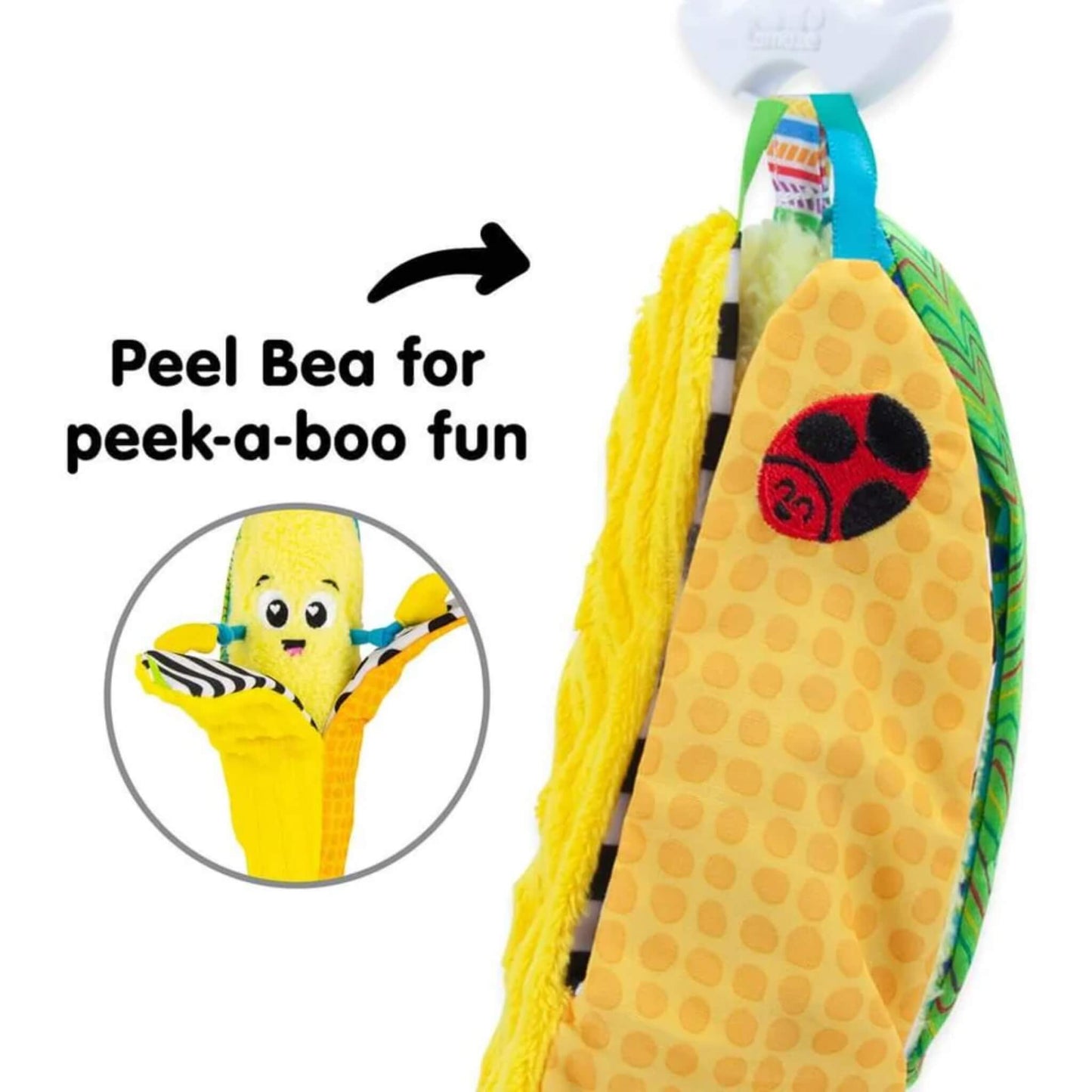 Yellow plush banana toy with a red ladybird patch on the peel, shown with an inset image revealing the smiling face hidden underneath for peek-a-boo play.