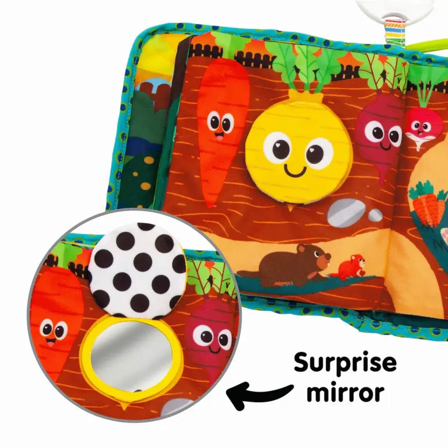Close-up of a soft fabric page with vegetable illustrations and an inset showing a circular surprise mirror for sensory discovery.