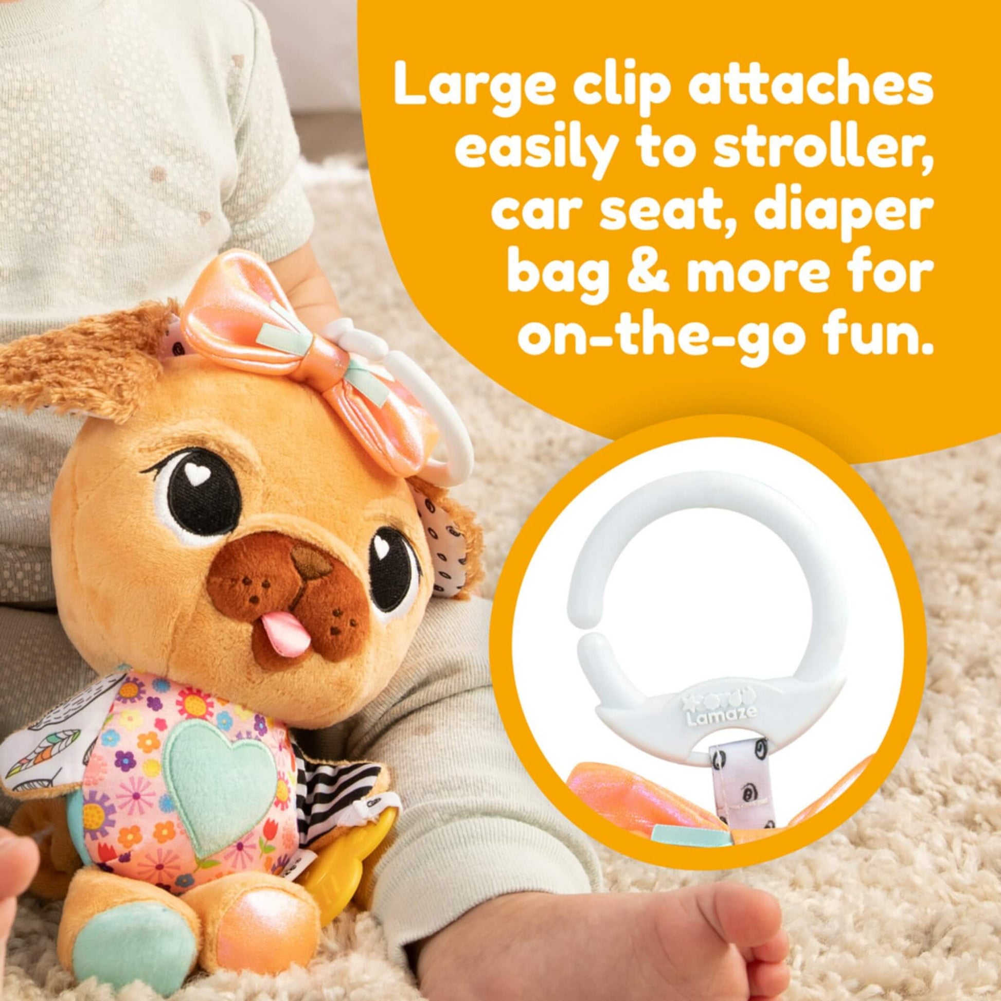 Baby playing on a rug holding a plush pug toy, with an inset close-up of the white plastic clip used to attach the toy to a pram or car seat.
