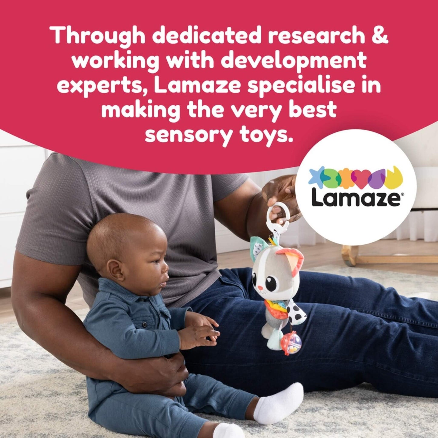 Father sitting on the floor with his baby, holding a colourful sensory toy with text above describing Lamaze’s focus on creating expertly developed baby toys, alongside the Lamaze brand logo.