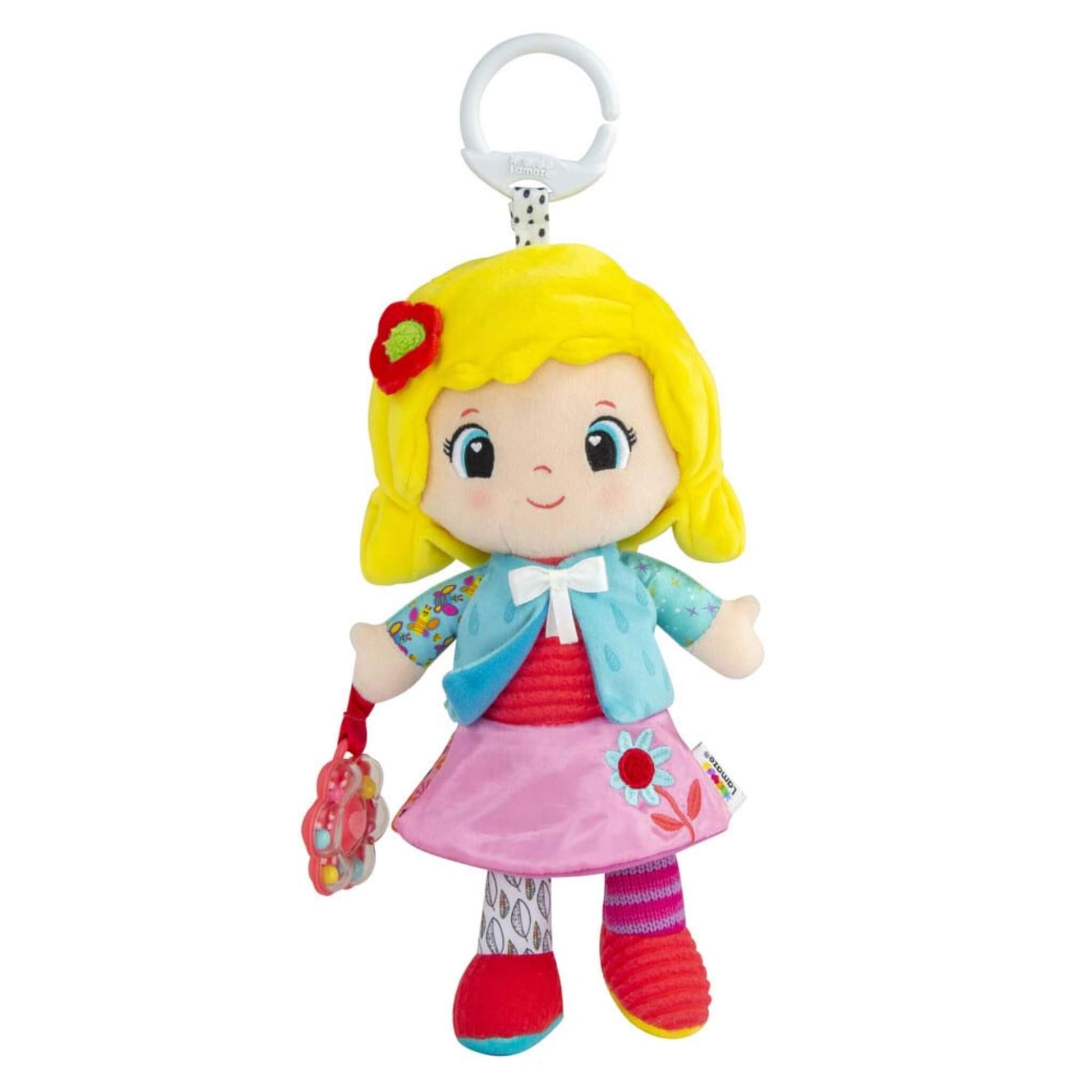 Lamaze My Friend Olivia soft baby doll toy with yellow hair, blue jacket and pink skirt, holding a flower-shaped rattle, with an on-the-go clip attached for pram or car seat use.