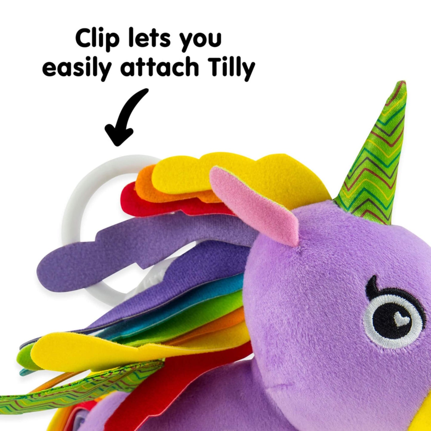 White plastic clip attached behind a soft unicorn toy’s mane for easy fastening to a pram or car seat.
