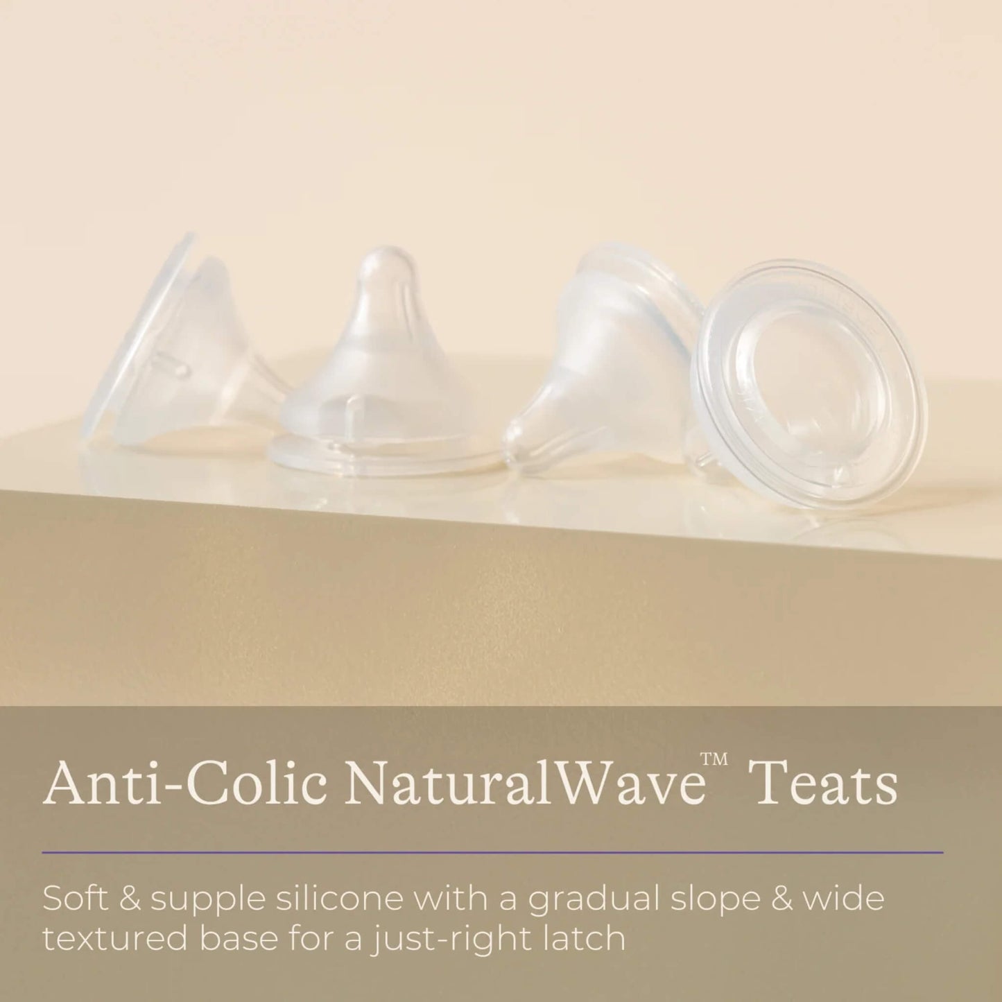Four clear silicone baby bottle teats displayed in a row on a neutral background with information highlighting soft silicone, gradual slope and wide textured base design.