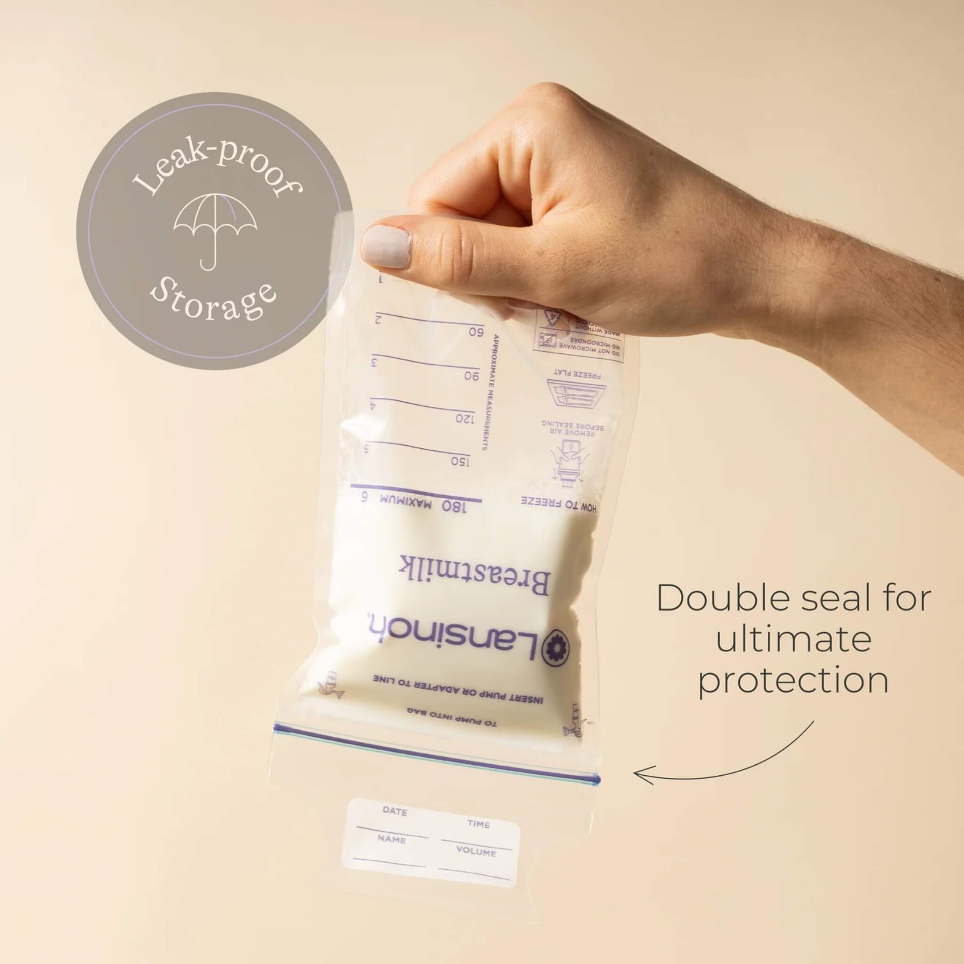 Hand holding a filled breastmilk storage bag upside down to demonstrate leak-resistant storage and double seal closure.