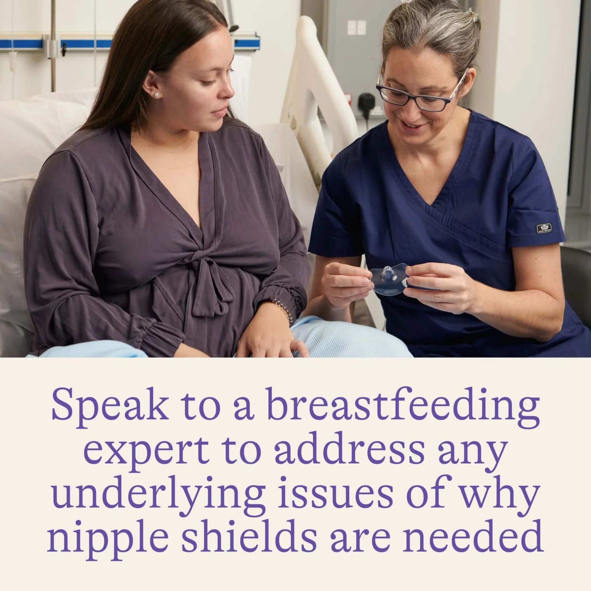 Healthcare professional demonstrating a transparent nipple shield to a seated parent in a maternity care setting.