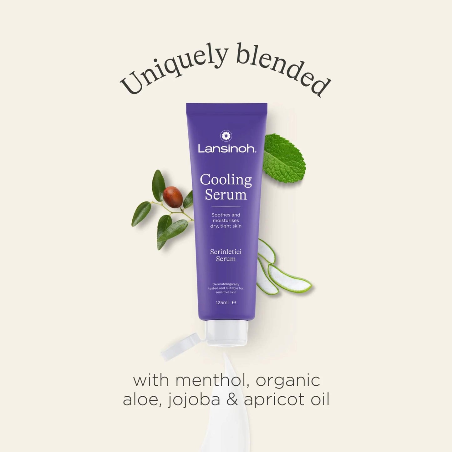 A tube of cooling serum surrounded by aloe leaves, mint leaves and botanical ingredients on a neutral background.