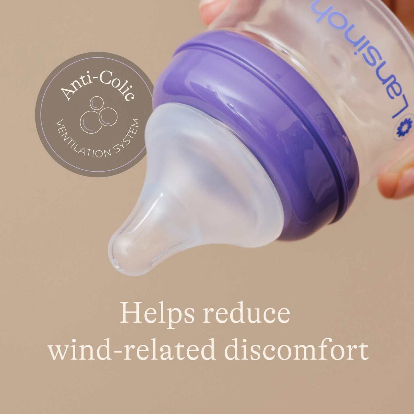 Close-up of a feeding bottle teat and collar showing an anti-colic ventilation system design.