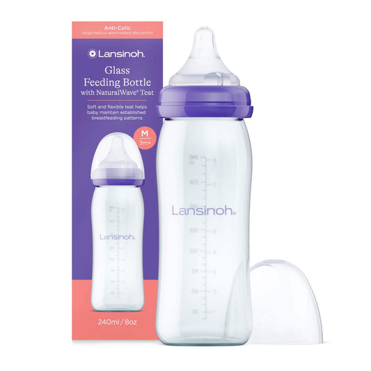 Lansinoh Glass Feeding Bottle with NaturalWave teat in 240ml size displayed beside branded retail packaging, featuring a clear glass bottle with purple collar, transparent teat and protective cap shown separately.