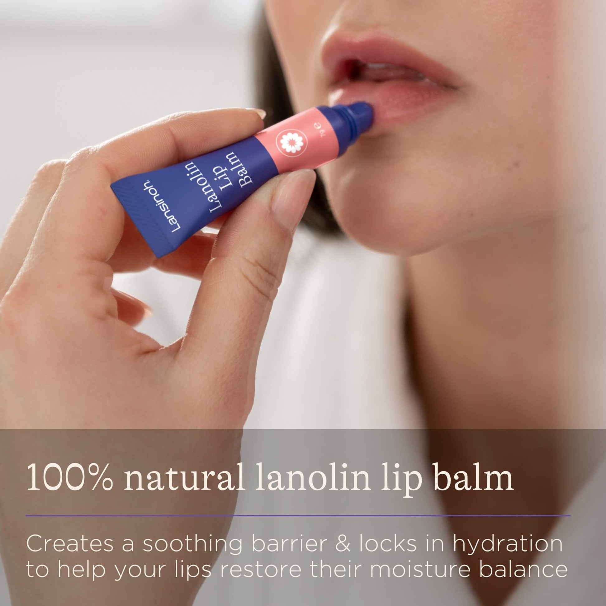 A close-up of a woman applying lip balm to her lower lip using the angled applicator, showing the product in use.
