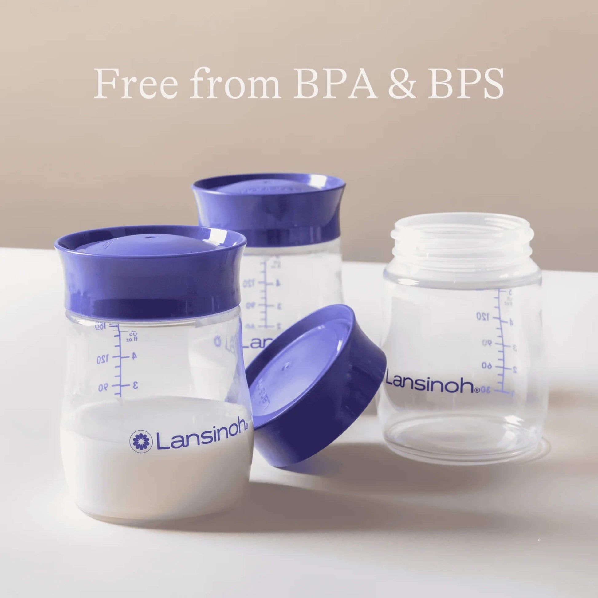 Three reusable breastmilk storage bottles with purple lids arranged on a surface, including one open bottle to show the screw thread opening and bottle shape.