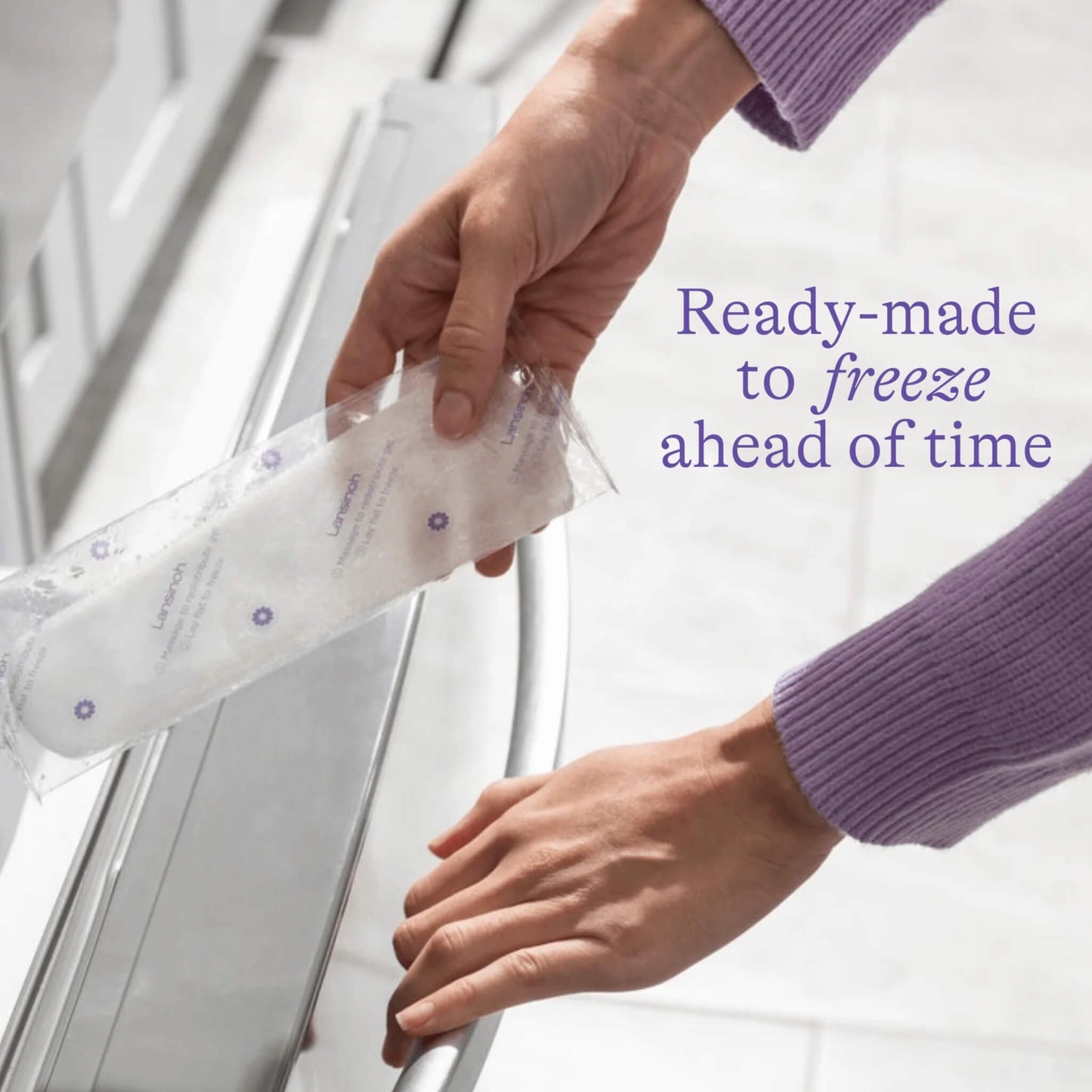 A woman placing a packaged postpartum padsicle into a freezer drawer, demonstrating preparation ahead of labour and recovery.