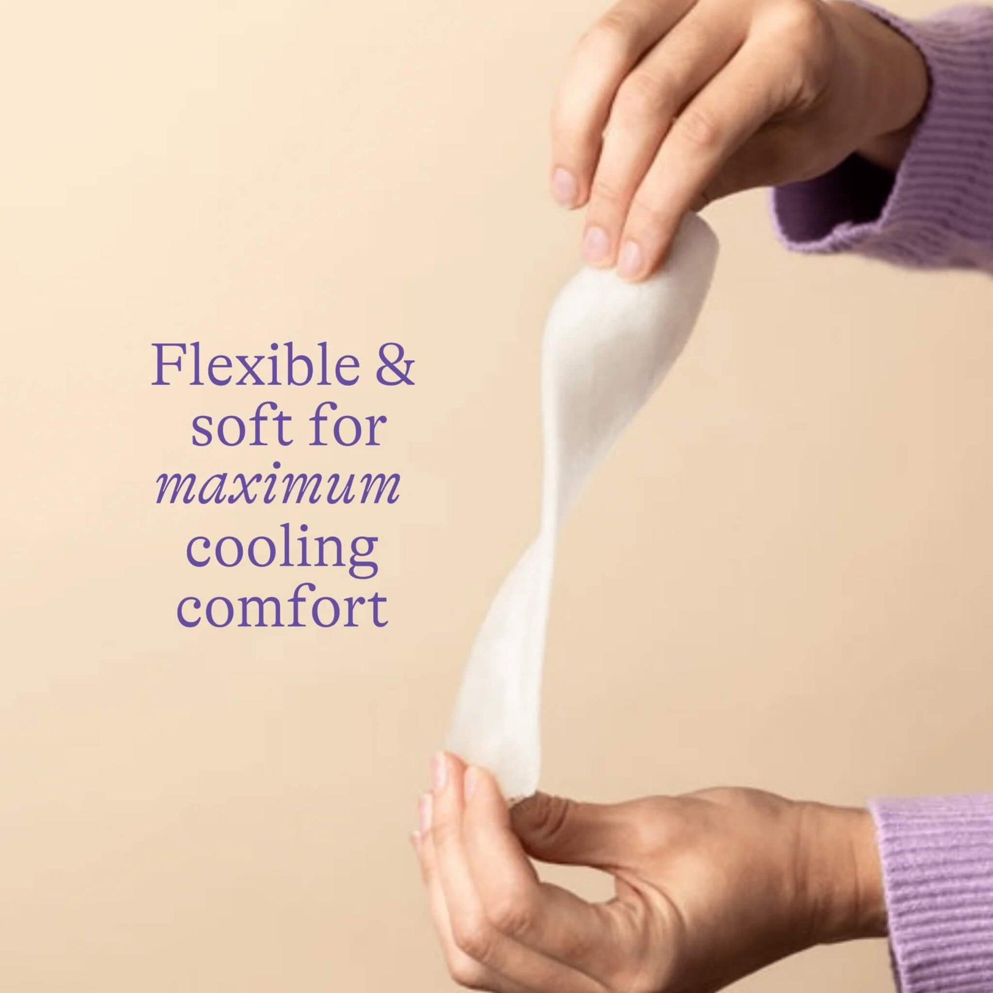 Hands gently stretching a soft postpartum padsicle to demonstrate its flexible design for comfortable cooling relief after birth.
