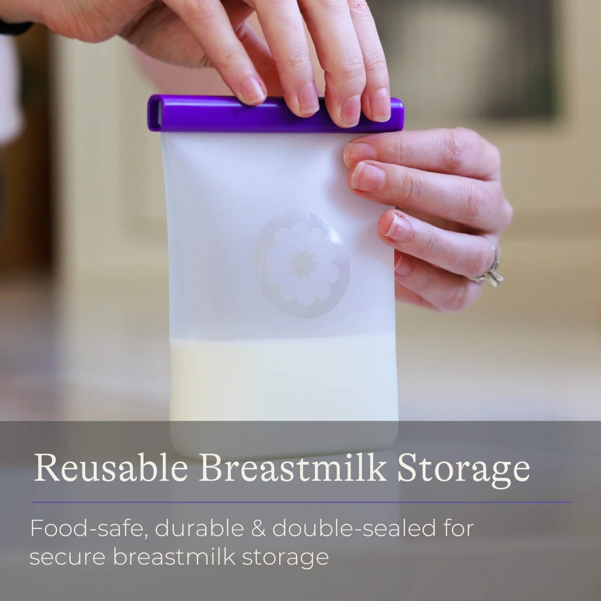 Hands sealing a reusable silicone breastmilk storage bag partially filled with milk using a purple double-seal bar.