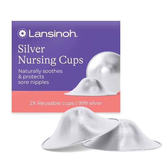Lansinoh Silver Nursing Cups shown in front of purple and coral packaging, featuring two concave 925 sterling silver cups designed to soothe and protect sore nipples naturally.