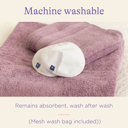 Two washable Nursing Pads resting on a folded towel, highlighting their machine-washable feature and consistent absorbency after multiple washes.