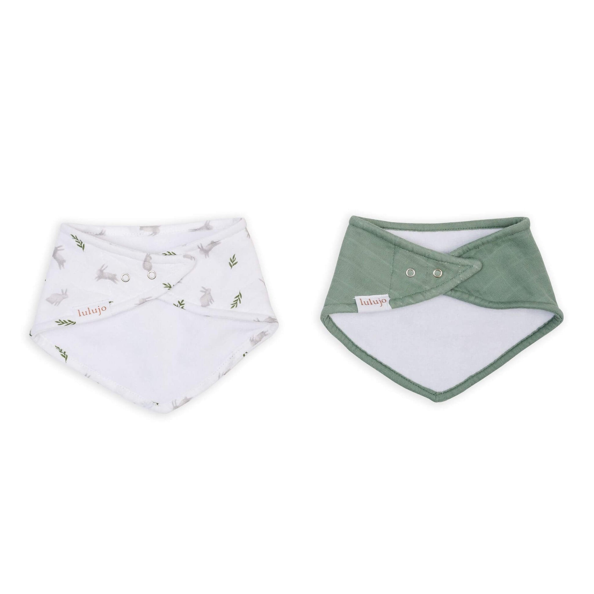 Lulujo bandana bibs with adjustable snaps shown from reverse side, featuring white bunny print and solid sage green, highlighting the practical design and quality construction.