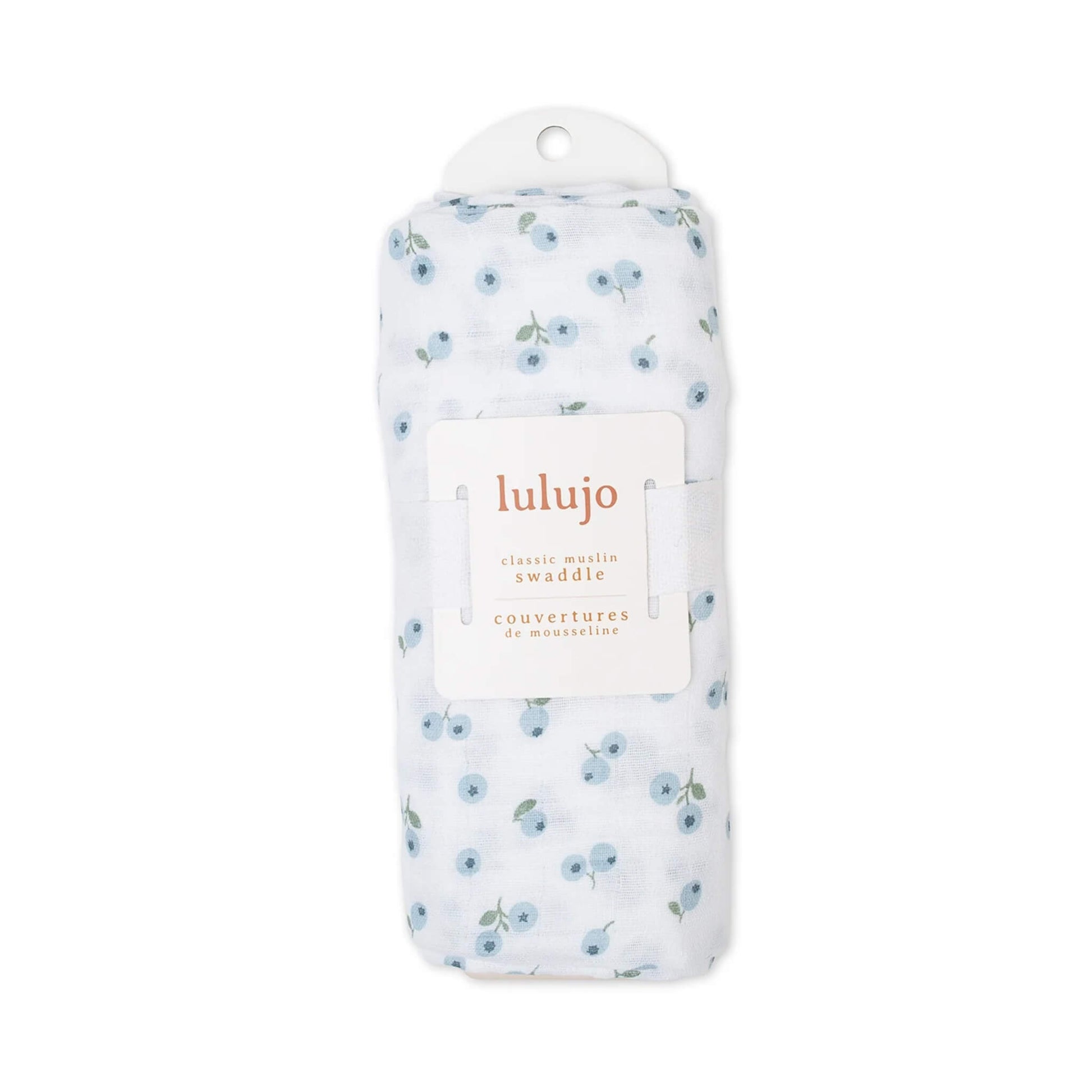 Muslin swaddle rolled in its Lulujo packaging with the label visible, showing the blue berry pattern through the folds.