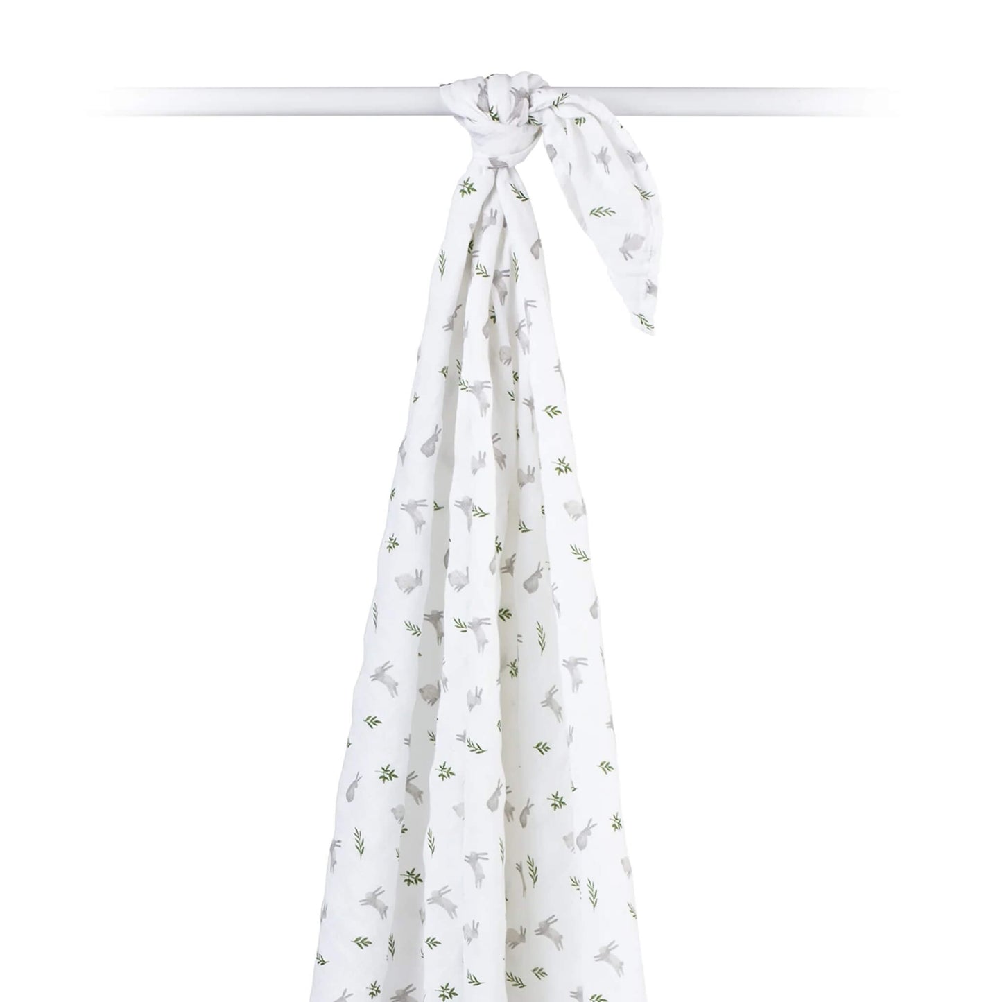 Cotton muslin swaddle draped over a rod, showing its airy, semi-sheer texture and all-over bunny print.