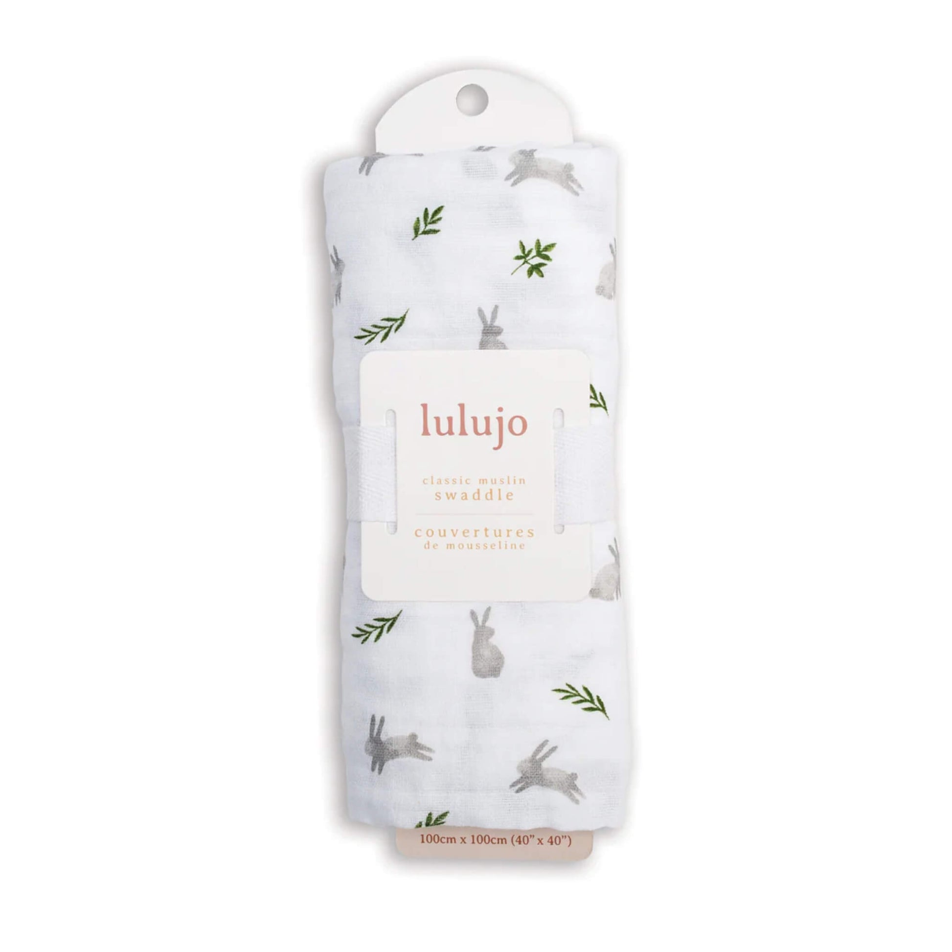 Swaddle rolled in its Lulujo packaging with the label visible, showing the grey bunny and green leaf pattern through the fabric.