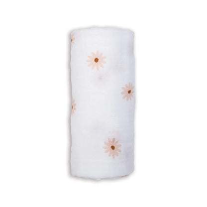 Lulujo Cotton Muslin Swaddle in the Daisies design, neatly rolled to show its soft white fabric patterned with gentle peach-toned daisy flowers.
