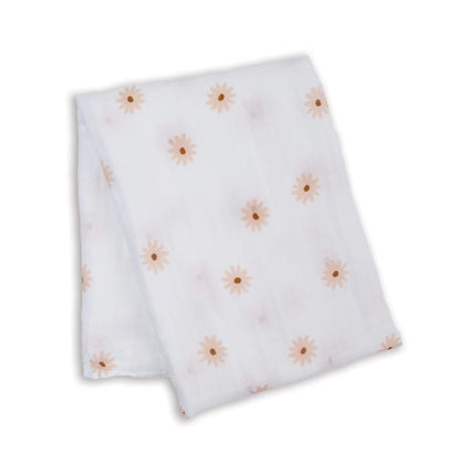 Lightweight muslin swaddle folded flat, showing a scattered pattern of soft peach daisies across the white cotton fabric.