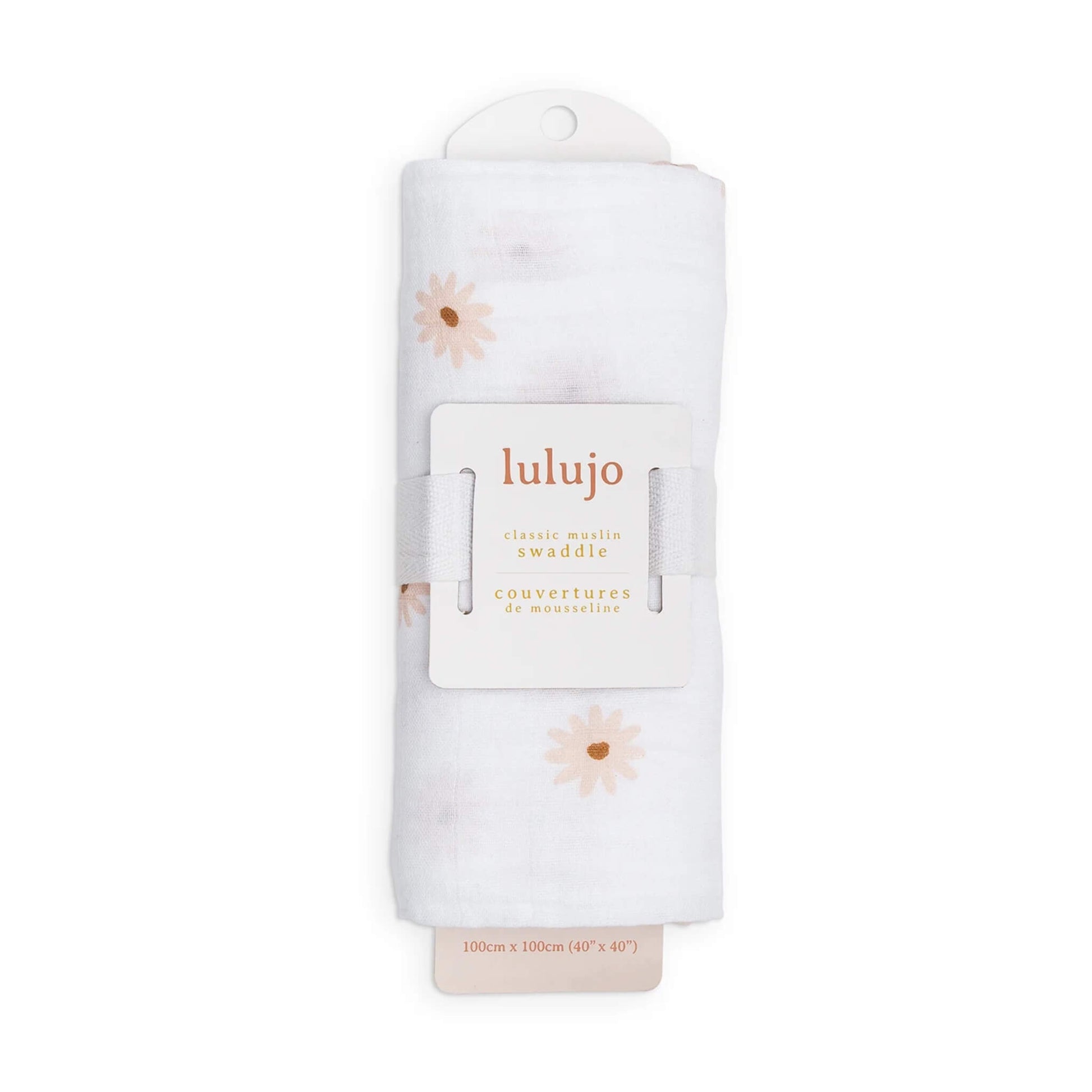 Swaddle rolled in its Lulujo packaging with the label visible, showing the subtle peach daisy design through the folds.