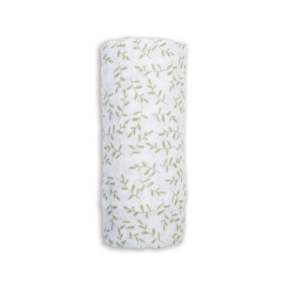 Lulujo Cotton Muslin Swaddle in the Greenery design, neatly rolled to show its soft white fabric patterned with delicate green leafy sprigs.
