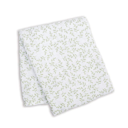 Lightweight muslin swaddle folded flat, showing a repeating pattern of fine green leaves across the white cotton fabric.