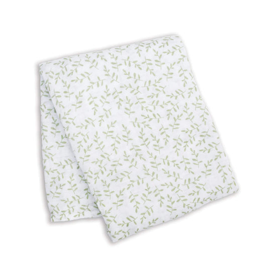 Lightweight muslin swaddle folded flat, showing a repeating pattern of fine green leaves across the white cotton fabric.