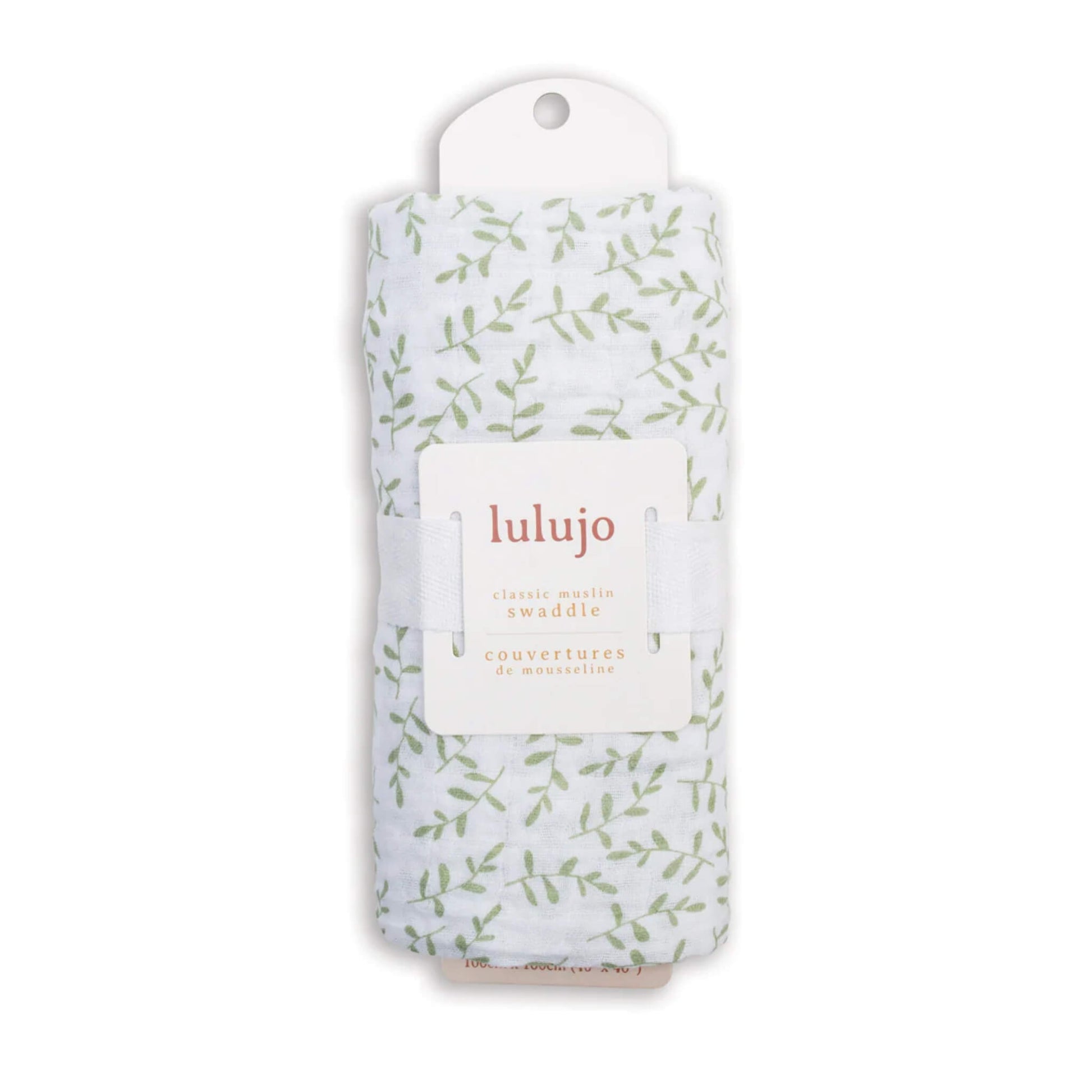 Swaddle rolled in its Lulujo packaging with the label visible, showing the pale green leaf pattern through the fabric.