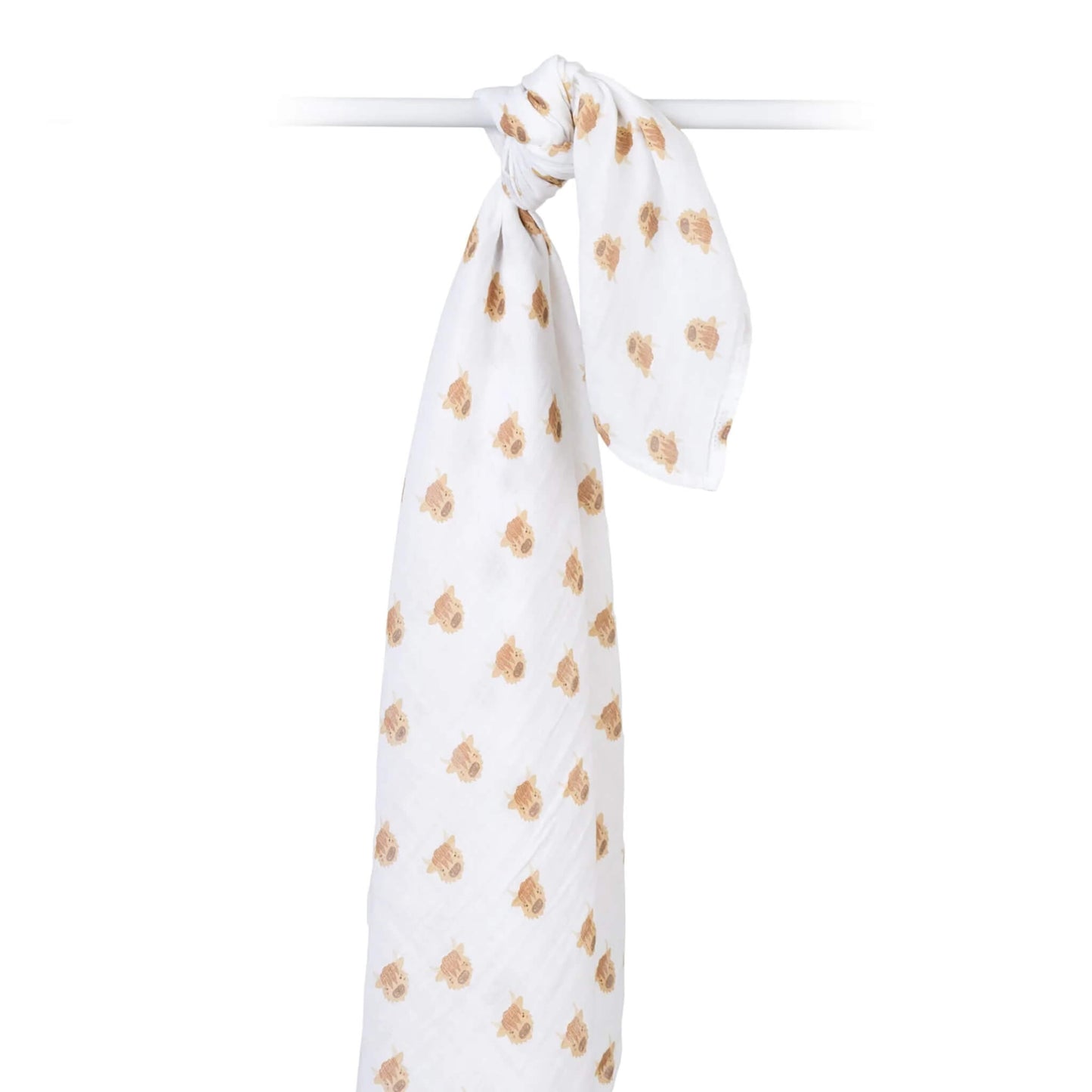 Cotton muslin swaddle draped over a rod, highlighting its airy weave and all-over Highland cow print.