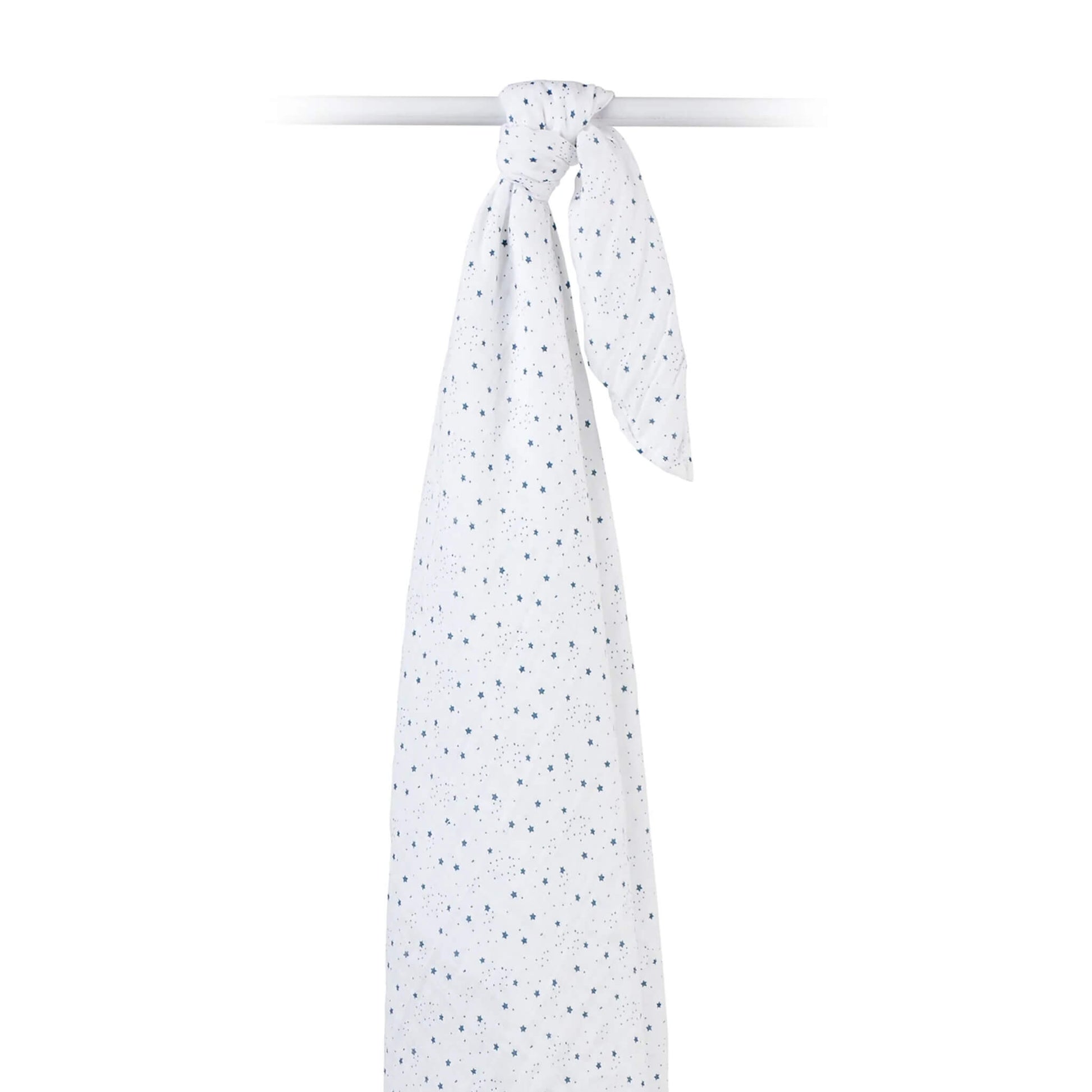 Muslin swaddle draped over a rod, highlighting the airy texture and scattered star print.