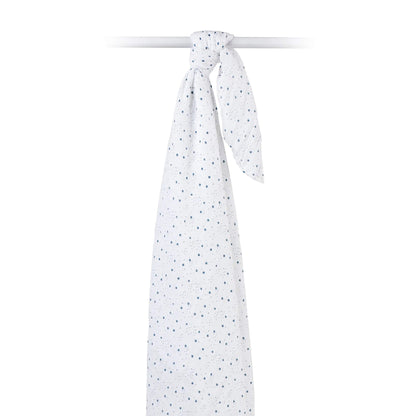 Muslin swaddle draped over a rod, highlighting the airy texture and scattered star print.