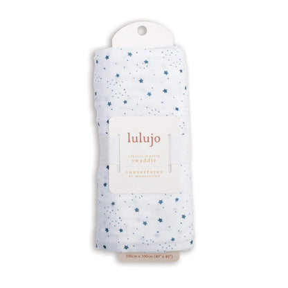Swaddle rolled in its Lulujo packaging with the white label visible, displaying the blue star design through the fabric.