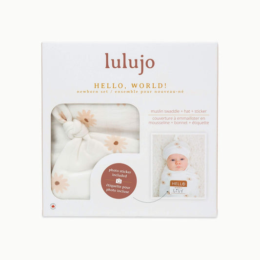Lulujo Daisies Hello World gift box packaging showcasing the muslin swaddle, knotted hat and photo name tag with baby Lily featured in sample photo.