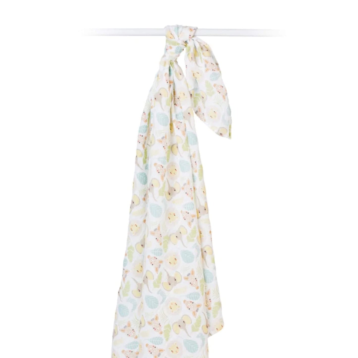 Lightweight muslin swaddle draped from a rail to display its airy texture and playful safari pattern of animals and leaves.
