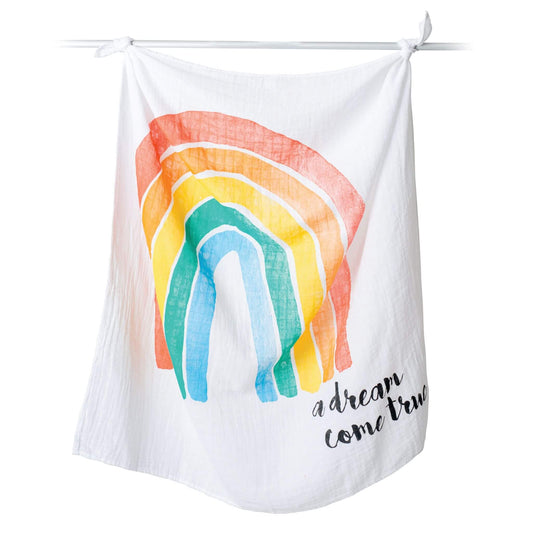 Lulujo "A Dream Come True" Milestone Muslin Blanket displayed on hanging rod showing the colourful rainbow design perfect for monthly baby photos.