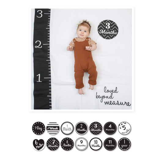 Lulujo Milestone Muslin Blanket & Cards Set "Loved Beyond Measure" showcasing 3-month-old baby in rust dungarees with growth ruler and milestone card.