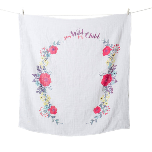 Lulujo "Stay Wild My Child" Milestone Muslin Blanket displayed on hanging line showing the beautiful floral wreath design perfect for monthly baby photos.
