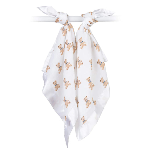 Pair of white muslin comfort blankets with teddy bear design, tied over a rail to display their lightweight fabric.