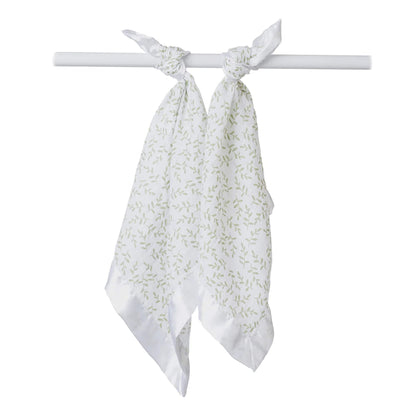 Two Lulujo baby comfort blankets tied for display, made from breathable muslin with a soft green leaf pattern and satin edges.