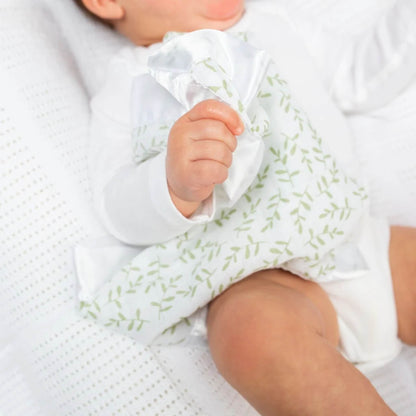 Baby cuddling a Lulujo muslin security blanket with greenery print and satin border—soft, soothing, and perfect for comfort on the go.