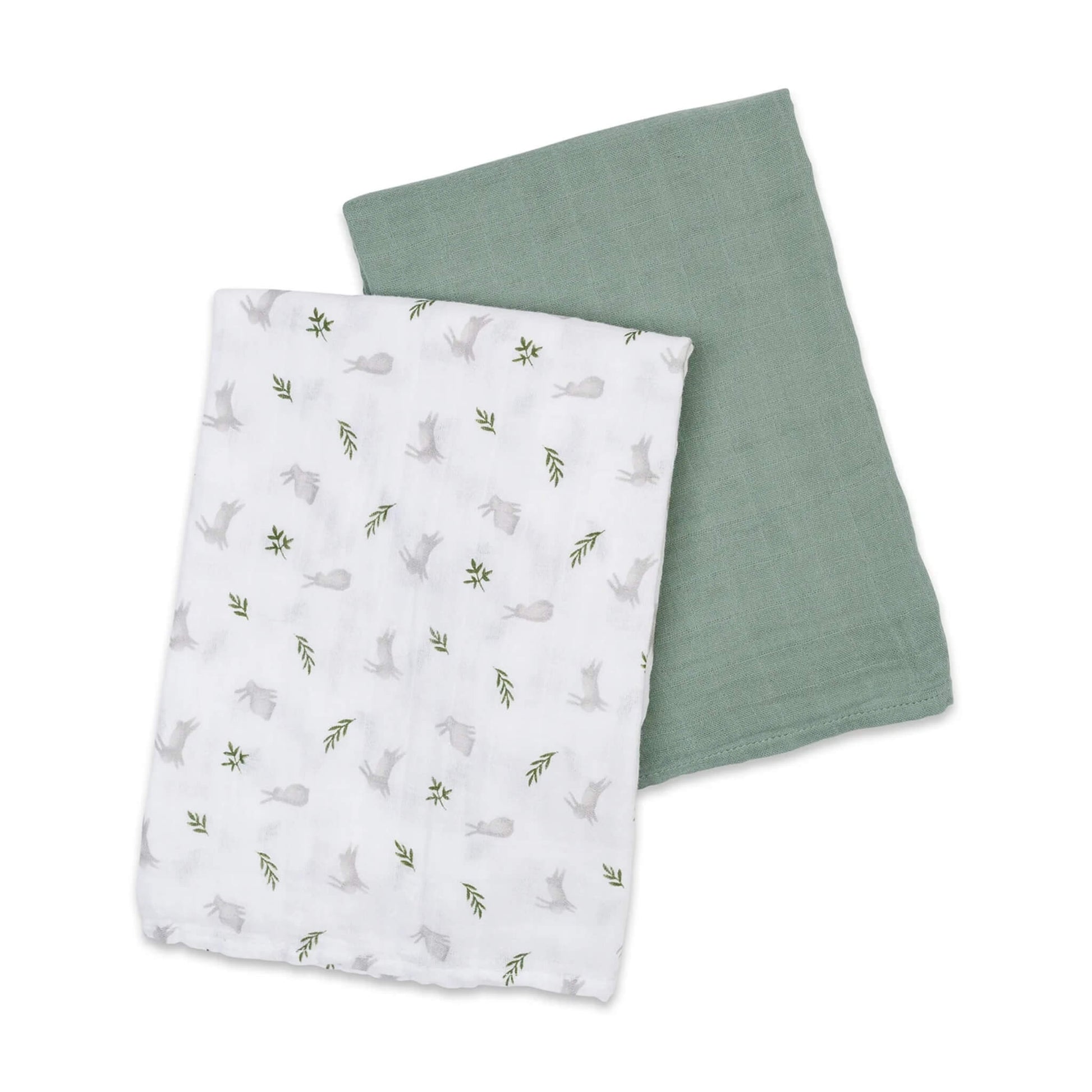 Two muslin swaddles laid flat, one solid green and one white patterned with grey bunnies and small green leaves.