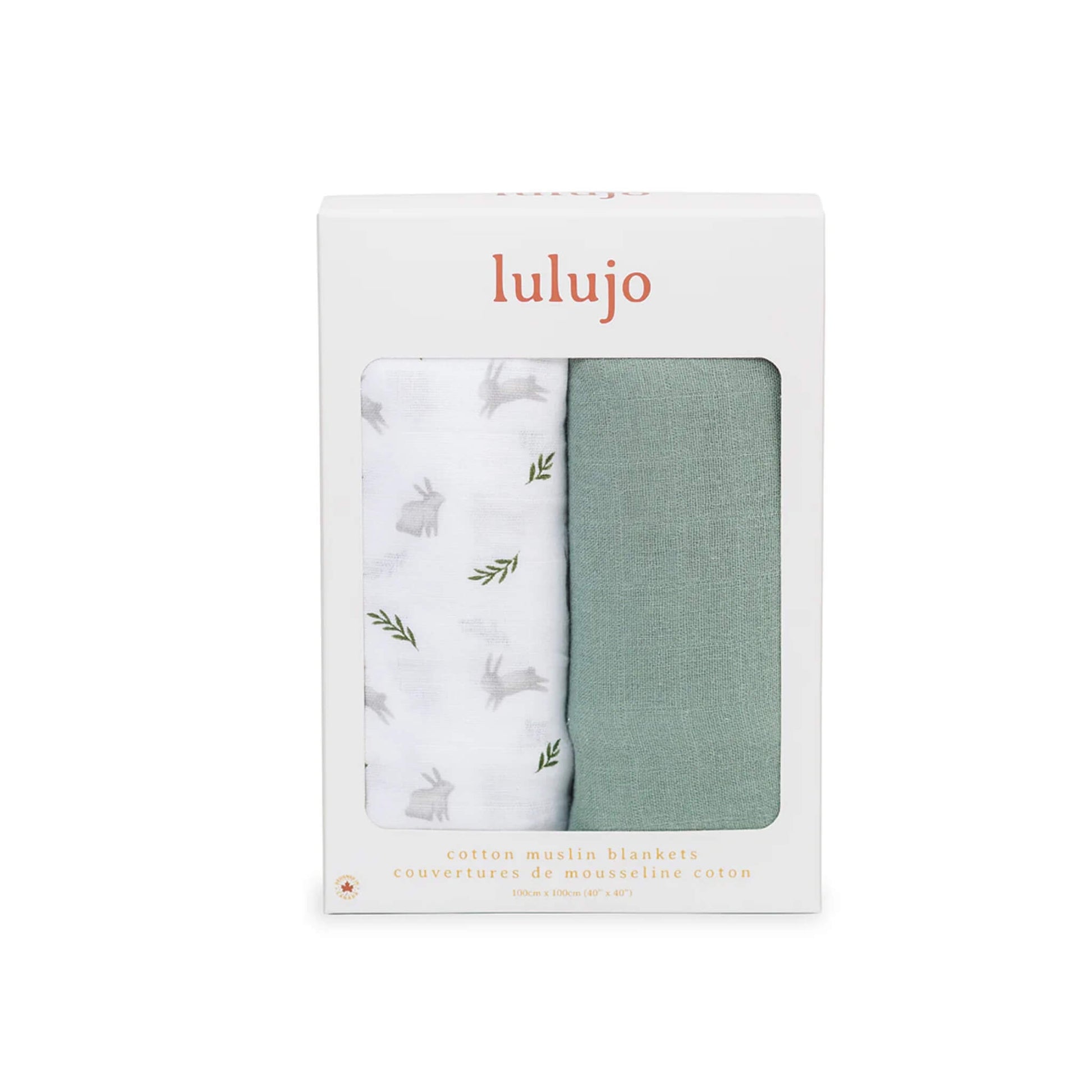 Boxed Lulujo 2-pack cotton muslin swaddles in packaging with one green and one white bunny-print blanket visible through the front window.